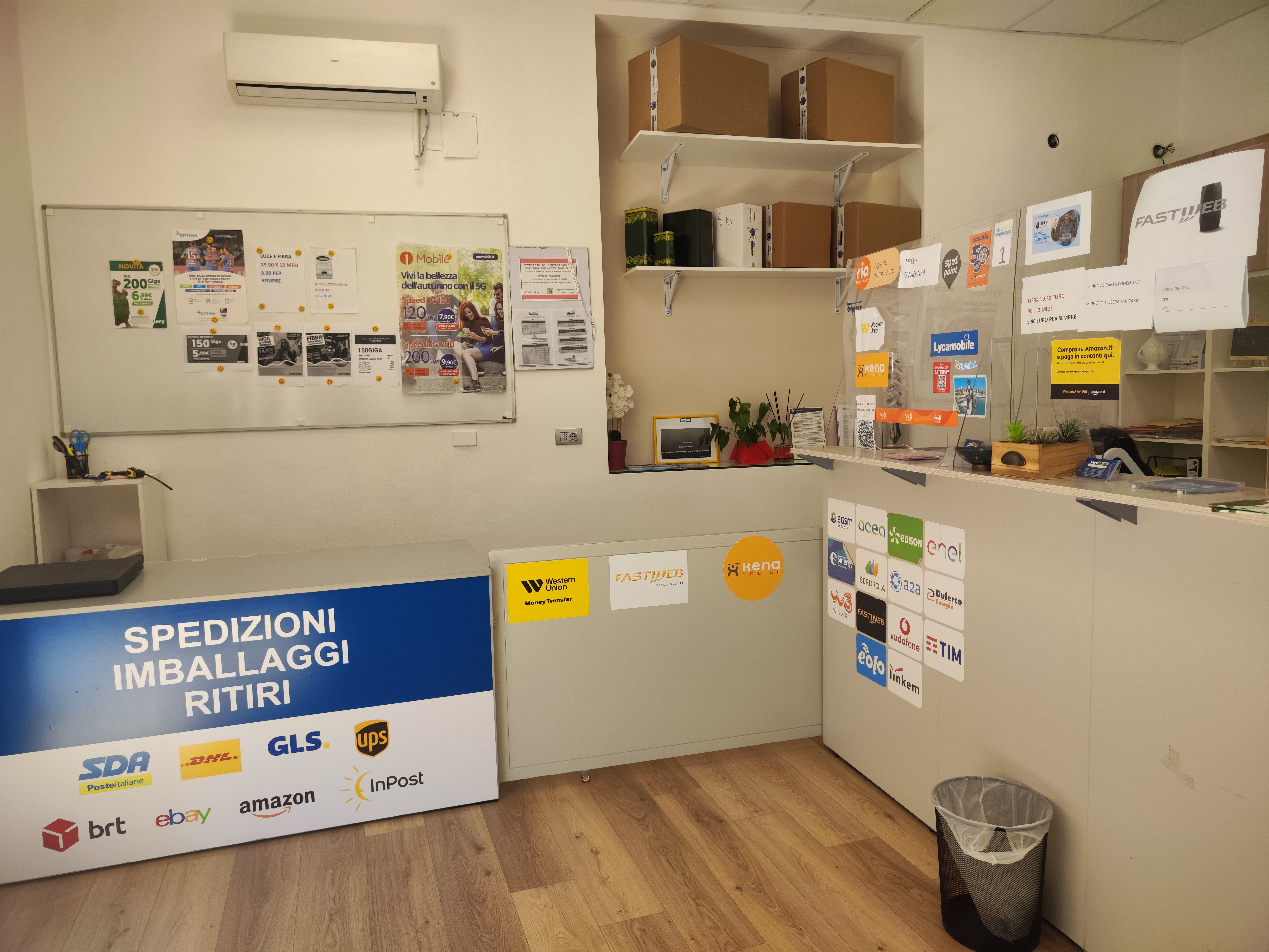 Vetrina esterna di un punto VeryPosta con insegna e grafica ufficiale